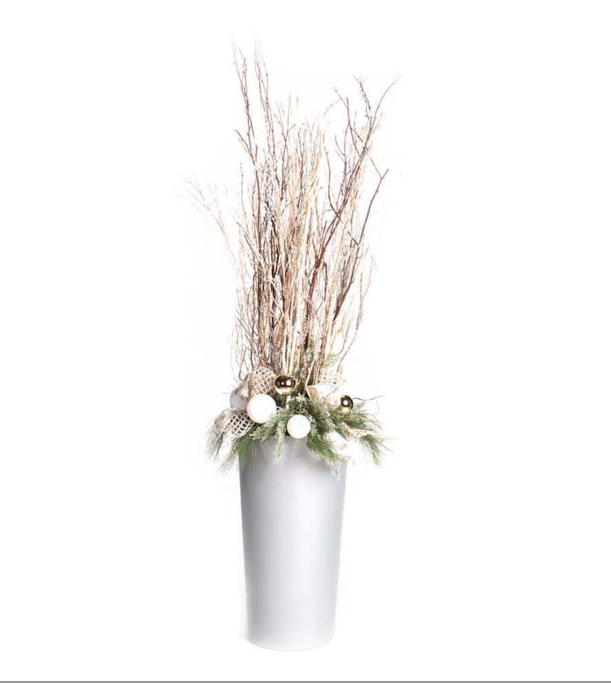 Natural branch display in a white planter